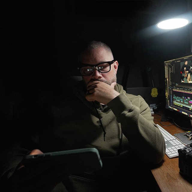James Korte at his editing desk, reviewing his phone